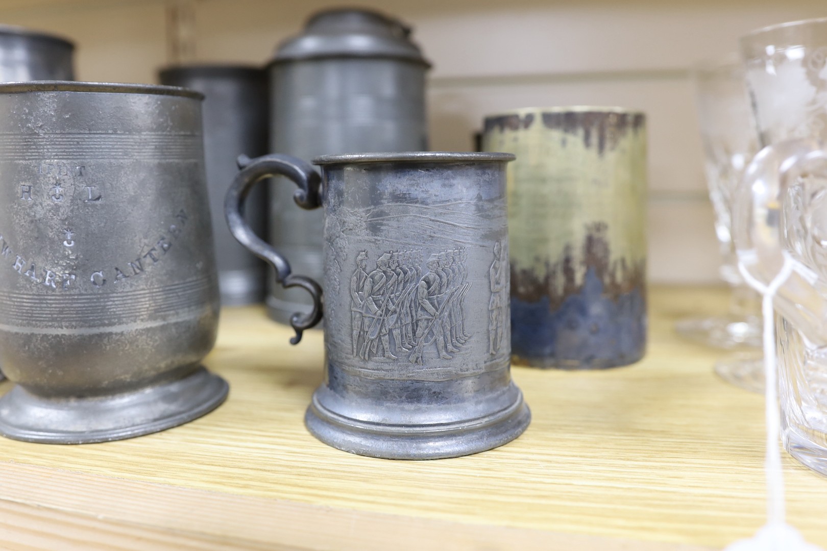 Seven pewter tankards relating to shooting clubs and artillery volunteers, and a smaller similar silver plated mug, tallest 21cm